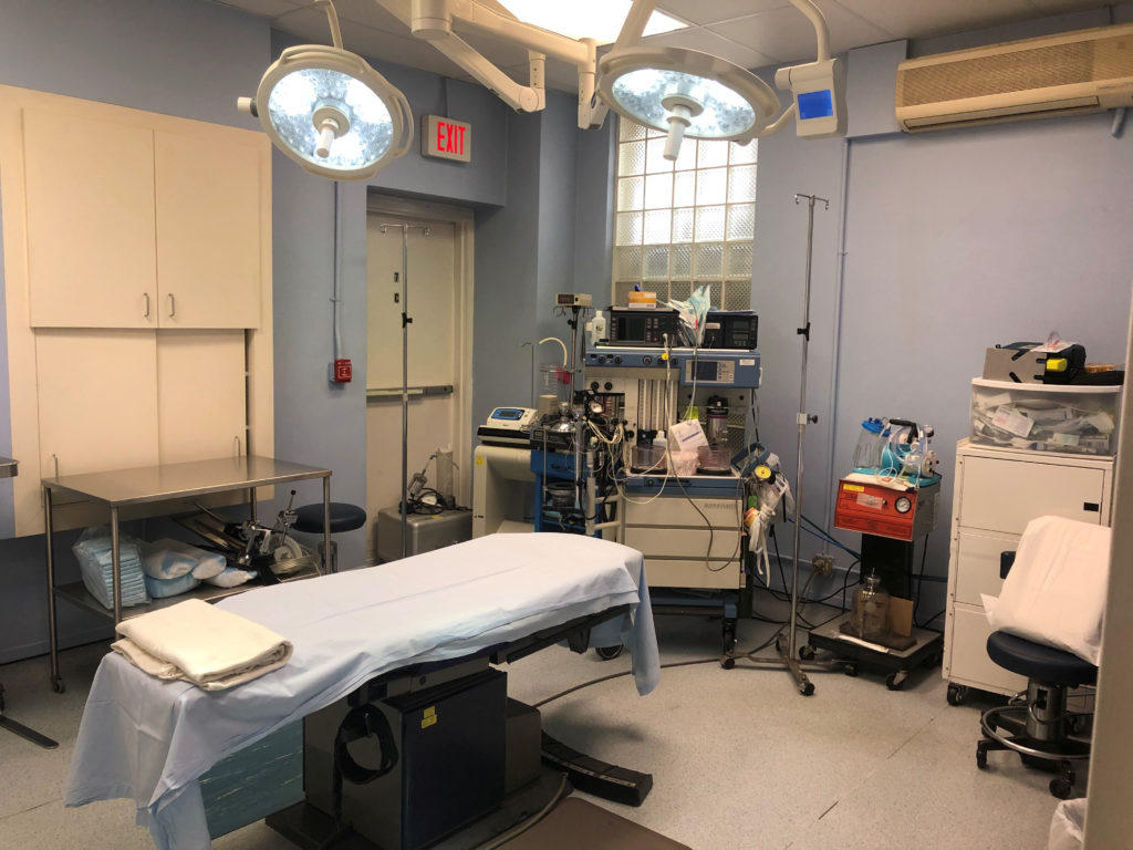 Hospital room with an empty bed and monitoring equipment